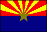 Image of the Arizona State flag.  The top half of the flag, with its 13 rays of red and yellow, represents both the 13 original colonies of the Union, and the rays of the Western setting sun. The lower half of the flag is a field of blue, the same Liberty Blue found in the United States' Flag. The red found in the rays of the setting sun is also the same shade of red found in the United States' Flag. The Blue of the lower half of the flag and the yellow of the western setting sun are the Arizona State Colors. The red and yellow colors found in the rays are the colors flown by the Spanish Conquistedores led by Francisco Vasquez de Coronado in his unsuccessful search for the Seven Cities of Cibola in 1540. Since Arizona was the largest producer of copper in the nation, a copper star was placed in the flag's center. The Arizona State Flag was adopted in 1917 by the Arizona State Legislature, despite numerous dissenting votes and then Governor Campbell's refusal to sign the bill.