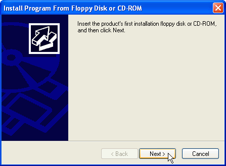 Screenshot of Install Program From Floppy Disk or CD-ROM dialog box, showing text message saying to insert the program's first disk or CD, with focus and mouse pointer on Next > button.