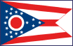 Image of the Ohio State Flag.  Unique among the state flags of the union, the Ohio State Flag was designed by John Eisemann. Described as a pennant, the Ohio burgee is properly a swallowtail design. The flag is similar to the Cavalry Guidon carried during the Civil War. The Ohio flag, unique in shape but uncomplicated in design, is filled with symbolism. The union of the flag, a large blue triangle, is populated with seventeen white stars. Those that are grouped around a white circle represent the thirteen original colonies. Four stars found at the apex of the triangle combine with the stars of the thirteen original colonies to total seventeen. Ohio was the seventeenth state to enter the union. Three red and two white horizontal stripes and the blue field copy the red, white and blue of the Stars and Stripes. The blue field represents Ohio's hills and valleys. The stripes represent the roads and waterways of the state. The white circle with a red center forms the 