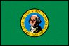 Image of the Washington State Flag.  The flag has a dark green field with the state seal in the center. The circular seal contains a picture of George Washington on a blue inner circular field.  It is surrounded by a gold border with black lettering containing the words 'THE SEAL OF THE STATE OF WASHINGTON' and '1889', the year Washington was admitted to the Union. The seal is edged in black. Washington has the only state flag that is green. It is also the only state flag with a picture of a president. The flag was adopted in 1923.